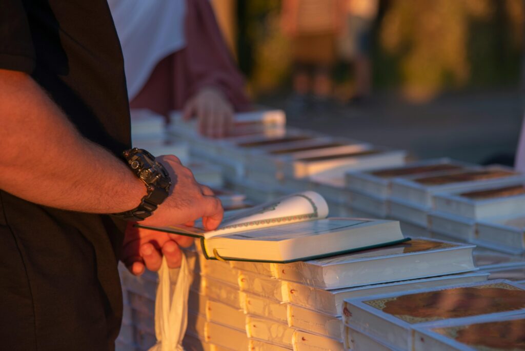 man flipping through book pages